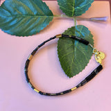 FRIIHOF+SIIG SORT/GULD PERLEARMBÅND MED FIREKANTET GLASPERLE OG GULD LÅS
Fint perlearmbånd med firekantet glasperler i farverne mat sort, guld, og skinne sort fra Friihof+Siig. Perlerne sidder på en wire snor og har en guld lås.
Wire snor
Små perler
Måler ca. 17,5 cm.
Forlænger måler ca. 1,5 cm.
Materiale: Messing og forgyldt med 16 karat guld.