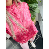 lyserød skjorte med zigzag mønster og flæse krave