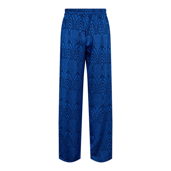 Skønne løse bukser med lige ben i den flotteste blå farve og med et fint print de har elastik i taljen og lommer i siden set bagfra