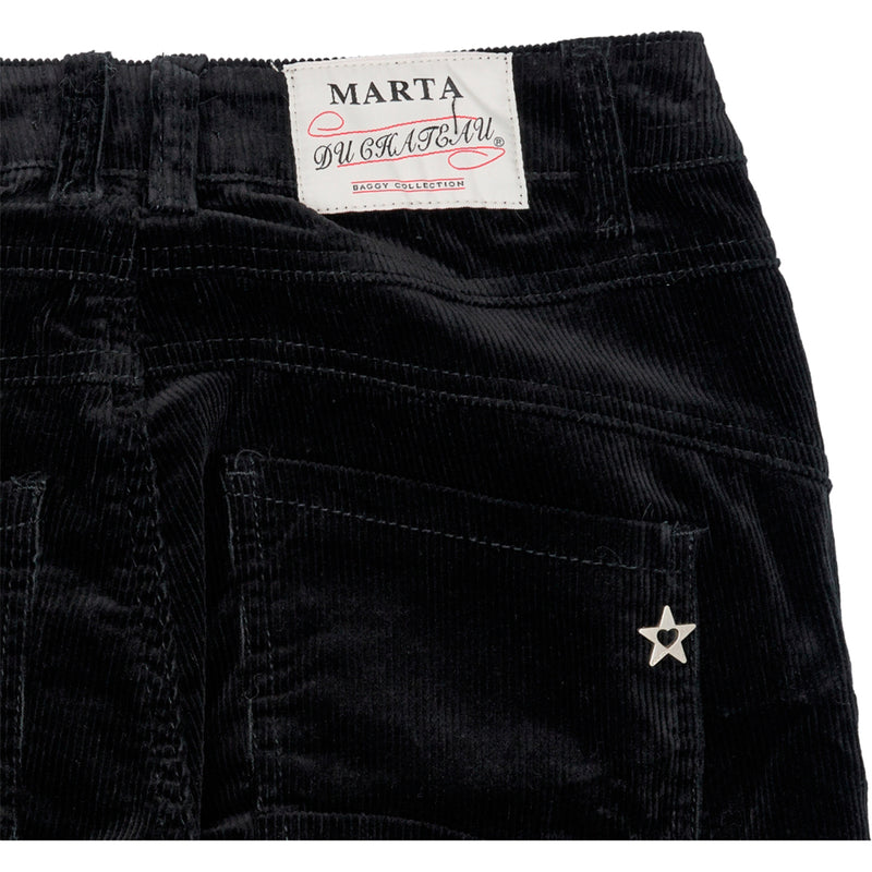 Sorte jeans med knapper smalle ben og 4 knapper den har lommer i siden og bagpå set bagpå hvor man kan se påsyet stjerne og marta mærke