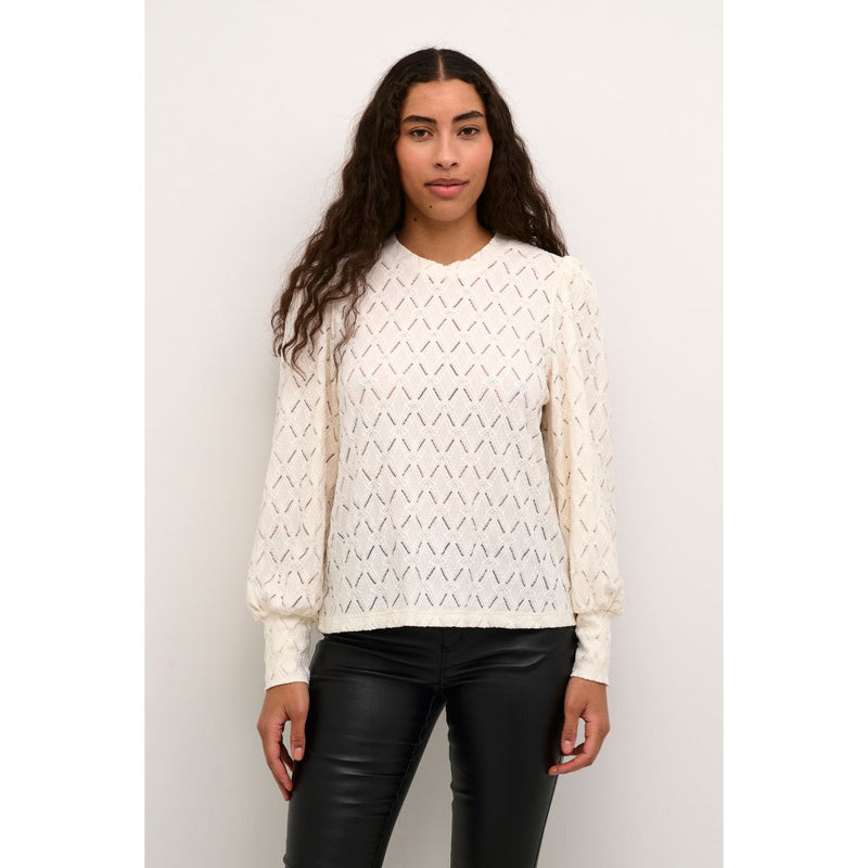 TINE LACE BLOUSE CHALK  Flot tætsiddende blondebluse fra Kaffe i en råhvid farve, Blonderne er i det fineste blomster mønster, der giver den et smukt og eksklusivt look. Den har rund hals og lange ærmer med et lille puf på skulderen.&nbsp;   Rund hals, lange ærmer med et lille puf, blonde og let gennemsigtig Mønster blomsterprint Farven er råhvid Tætsiddende pasform