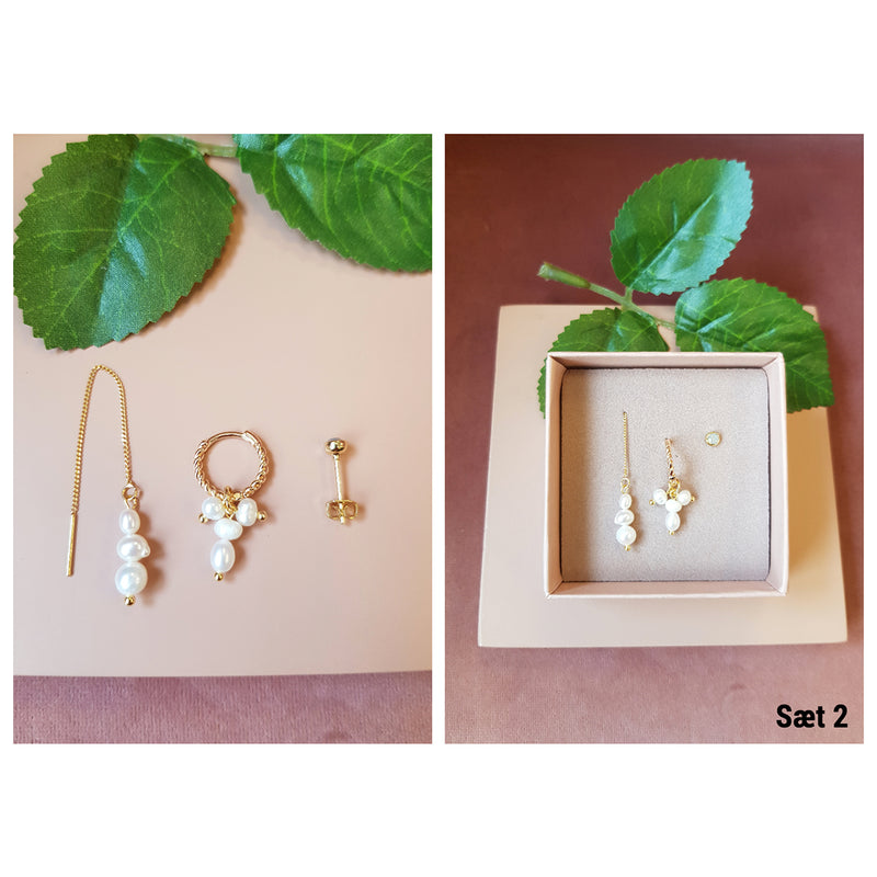 3 forskellige øreringe med perler sten og kæde set oppefra og i æske