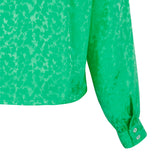 Smuk grøn bluse fra struktur mønster lange ærmer og stolpe fortil set tæt på ærme